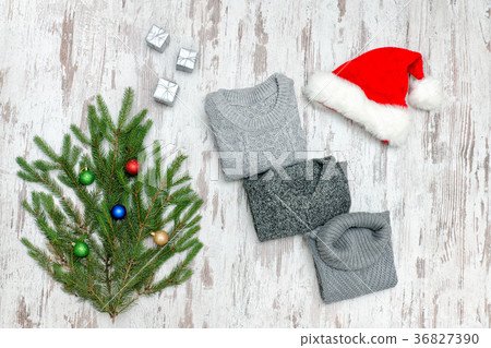 Three gray sweaters, Santa's hat and fir branch 36827390