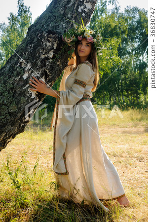 Pretty woman with flower wreath 36830747