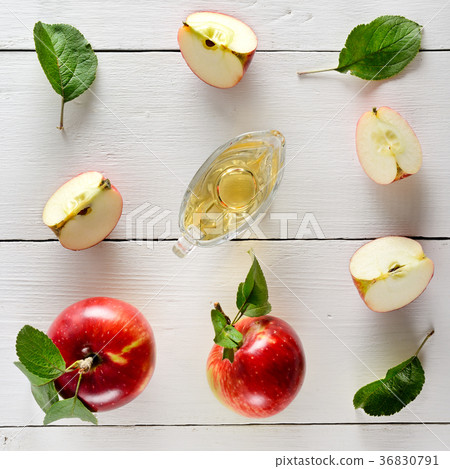 Fresh apples and vinegar on wooden table  36830791