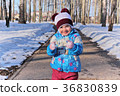 Little girl in winter sunny day 36830839
