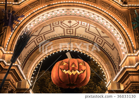 Big Halloween pumpkin hanging in archway 36833130
