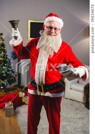 Santa claus ringing a bell at home Santa claus ringing a bell at home 36834678