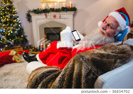 Santa claus using mobile phone at home 36834702