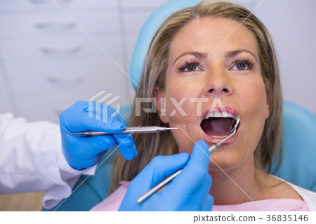 Doctor giving dental treatment to woman at clinic 36835146