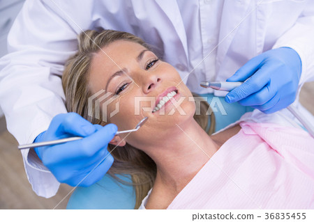 High angle portrait of woman by dentist dolding tool High angle portrait of woman by dentist dolding tool 36835455