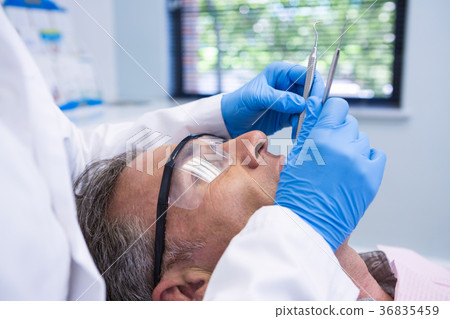 Doctor giving dental treatment to patient Doctor giving dental treatment to patient 36835459
