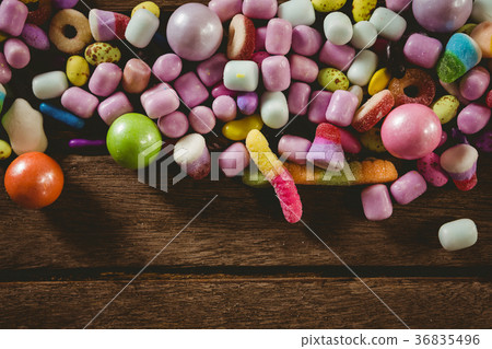 Close up of various candies on wooden table Close up of various candies on wooden table 36835496