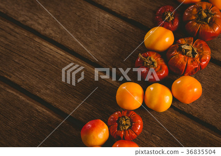 Close up of candies with small pumpkins on table 36835504
