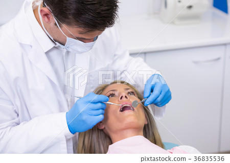 Dentist examining woman at dental clinic Dentist examining woman at dental clinic 36835536