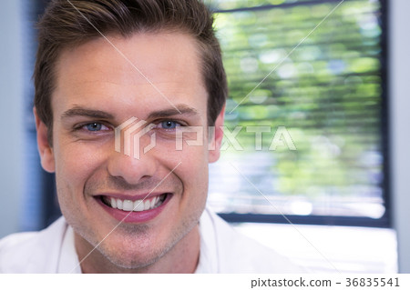 Dentist standing against window at clinic Dentist standing against window at clinic 36835541