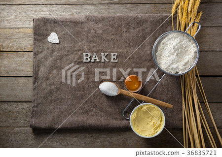 Wheat stem, wear flour, sieve, spoon placed over a cloth on wooden table Wheat stem, wear flour, sieve, spoon placed over a cloth on wooden table 36835721