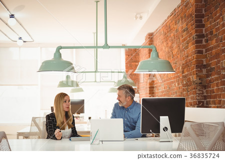 Executive interacting with each other at desk Executive interacting with each other at desk 36835724