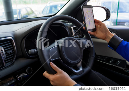 Cropped image of woman using phone during test drive 36835931