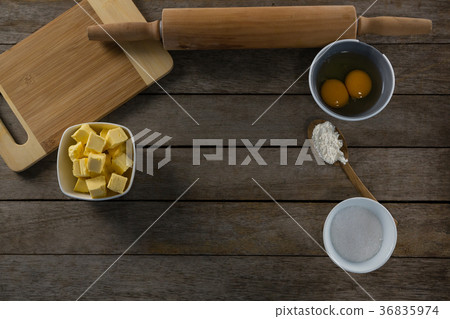 Cheese cubes and egg yolk on a wooden table 36835974