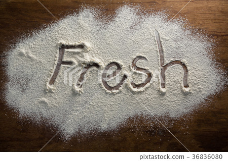The word fresh written on sprinkled flour 36836080