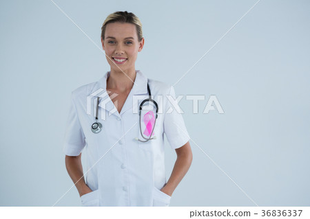 Portrait of smiling female doctor with Breast Cancer Awareness ribbon Portrait of smiling female doctor with Breast Cancer Awareness ribbon 36836337