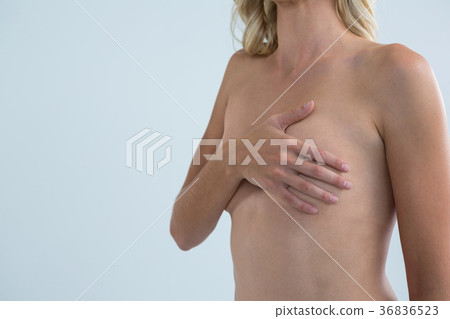 Shirtless woman with hand on chest Shirtless woman with hand on chest 36836523