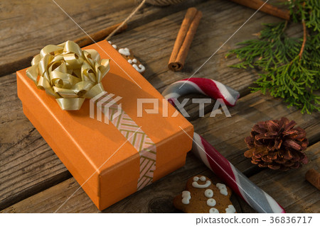 Close up of gift box by candy cane and spice Close up of gift box by candy cane and spice 36836717