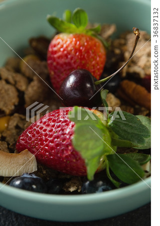 Bowl of breakfast cereals with fruits on black background Bowl of breakfast cereals with fruits on black background 36837132