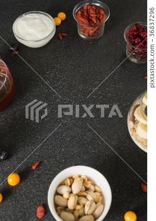 Various dried fruits with cup of yogurt muesli, banana and blueberries for breakfast Various dried fruits with cup of yogurt muesli, banana and blueberries for breakfast 36837296