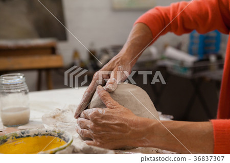 Mid-section of senior woman molding clay Mid-section of senior woman molding clay 36837307