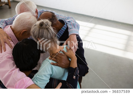 High angle view of senior male and female friends huddling 36837589