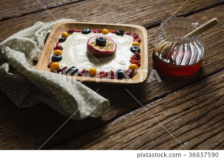Fruit yogurt and honey on a wooden table 36837590