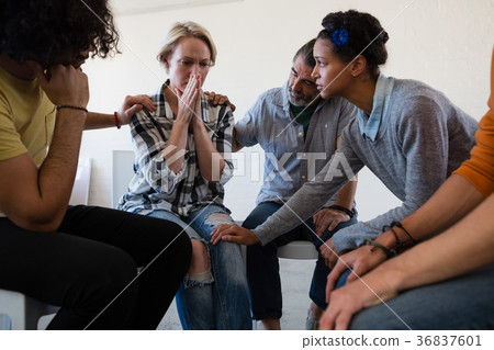 Friends consoling worried woman 36837601
