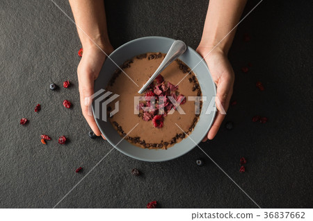Hands holding a bowl of fruit cereal Hands holding a bowl of fruit cereal 36837662