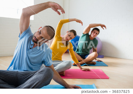 Yoga instructor with students exercising at club Yoga instructor with students exercising at club 36837825