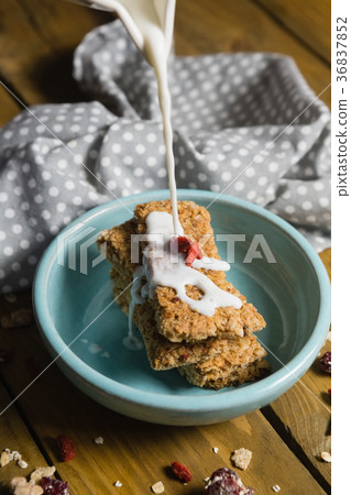 Milk being poured on granola bar 36837852