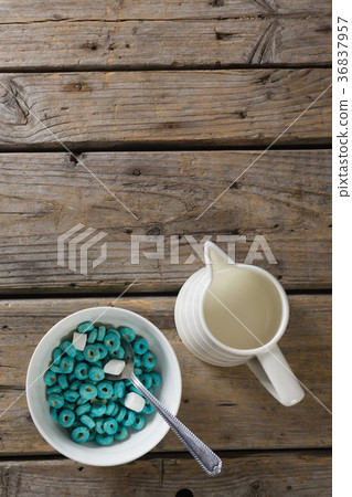 Bowl of froot loops and marshmallow with milk jug 36837957