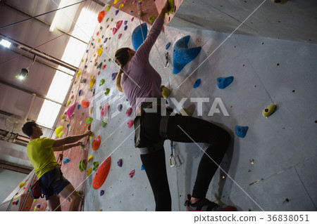 Low angle view of athletes rock climbing in fitness club 36838051