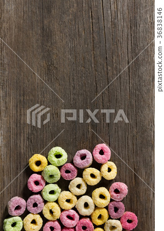 Froot loops arranged on wooden table 36838146