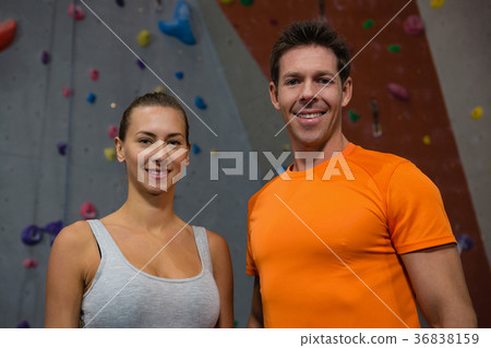 Portrait of confident athletes against climbing wall in gym Portrait of confident athletes against climbing wall in gym 36838159