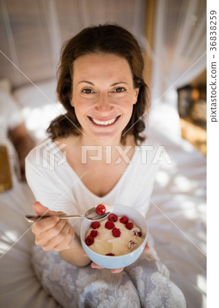 Portrait of happy woman having breakfast 36838259