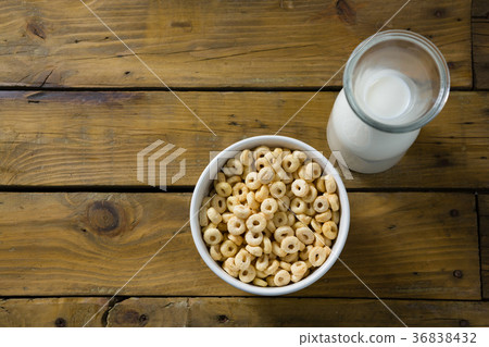 Cereal rings and milk on wooden table Cereal rings and milk on wooden table 36838432