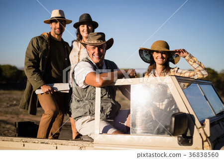 Portrait of happy friends enjoying in vehicle during safari vacation 36838560