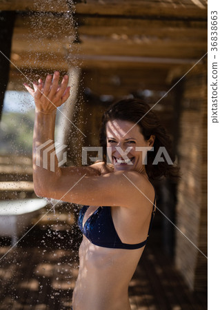Smiling woman taking bath in shower Smiling woman taking bath in shower 36838663