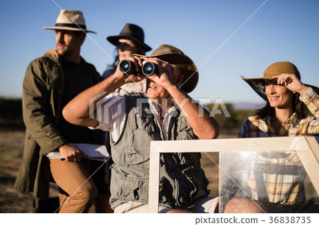 Happy friends enjoying in vehicle during safari vacation Happy friends enjoying in vehicle during safari vacation 36838735