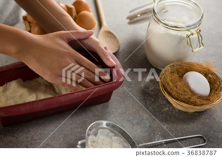 Woman preparing dough surrounded with various ingredients Woman preparing dough surrounded with various ingredients 36838787