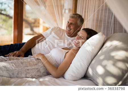 Senior couple sleeping on canopy bed 36838798