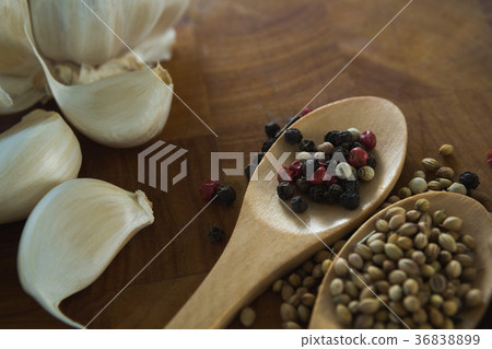 Garlic bulbs and spices on wooden board 36838899