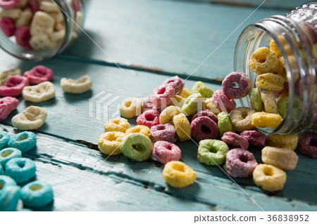 Cereal rings spilling out of bottle 36838952