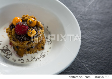 Granola bars with raspberry and golden berry in plate 36838988