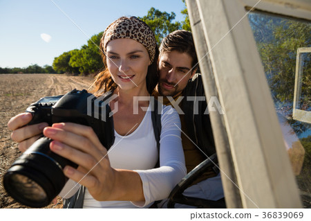 Couple looking at camera in off road vehicle Couple looking at camera in off road vehicle 36839069
