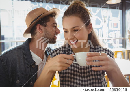 Woman with man holding coffee cup Woman with man holding coffee cup 36839426
