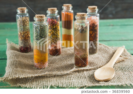 Various spices in bottles on wooden table Various spices in bottles on wooden table 36839560