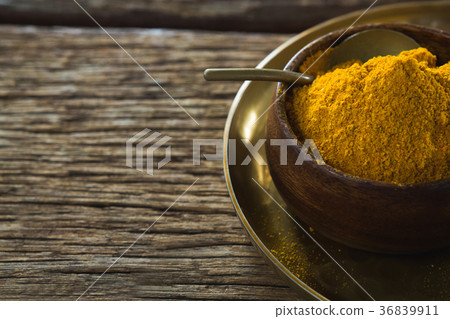 Turmeric powder in plate 36839911