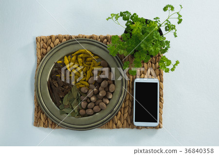 Various spices on plate with mobile phone Various spices on plate with mobile phone 36840358